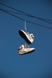 Why do you see pairs of shoes hanging from power lines?